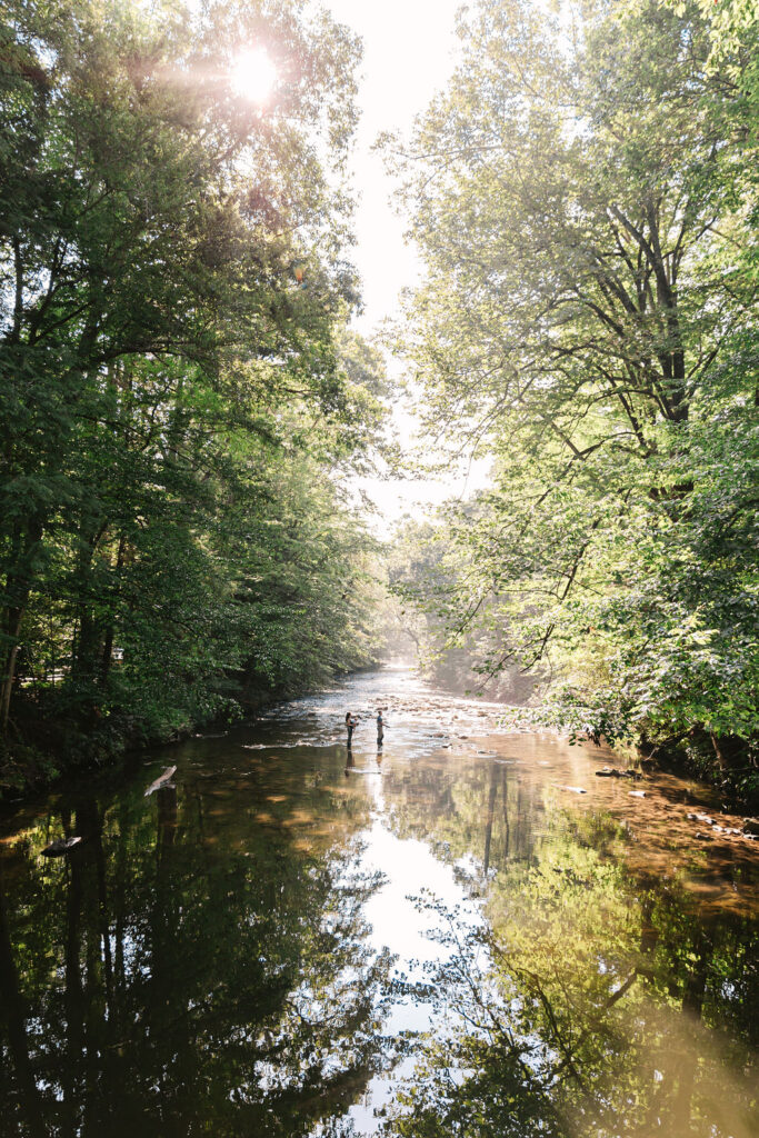 Family goes fly fishing together in the Davidson River in Brevard, North Carolina near Hendersonville and Asheville, NC and is photographed by asheville family photographer Rachel Marie Photography