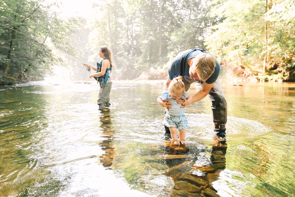 Family goes fly fishing together in the Davidson River in Brevard, North Carolina near Hendersonville and Asheville, NC and is photographed by asheville family photographer Rachel Marie Photography