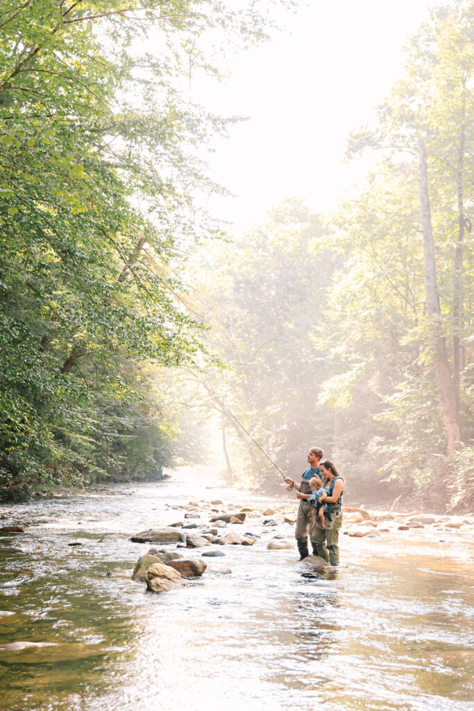 Family goes fly fishing together in the Davidson River in Brevard, North Carolina near Hendersonville and Asheville, NC and is photographed by family photographer Rachel Marie Photography