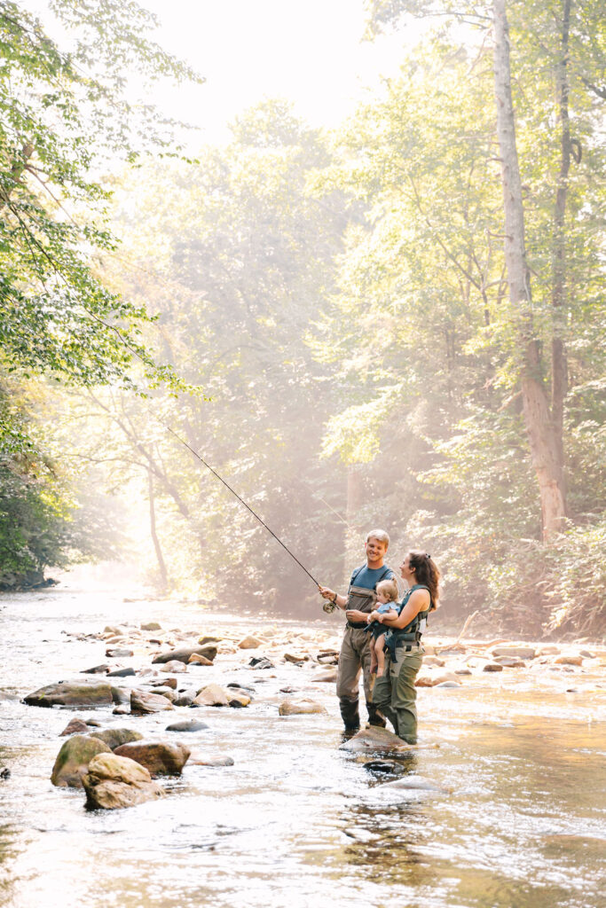 Family goes fly fishing together in the Davidson River in Brevard, North Carolina near Hendersonville and Asheville, NC and is photographed by family photographer Rachel Marie Photography