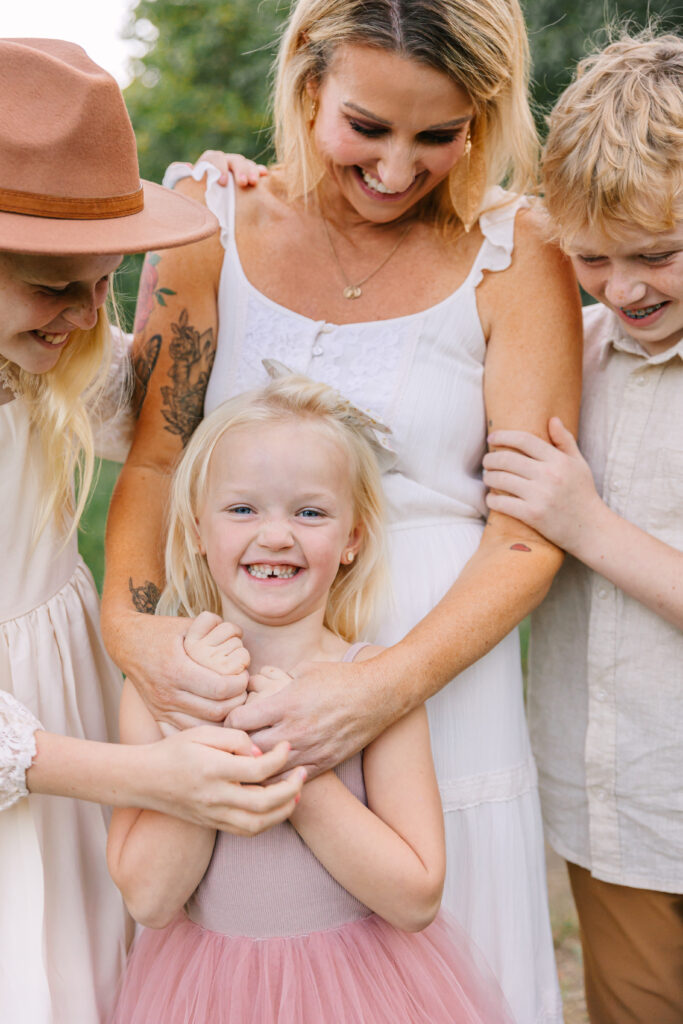 kids smiling and laughing during family photos with mom and kids during family photo session with Rachel Marie Photography 