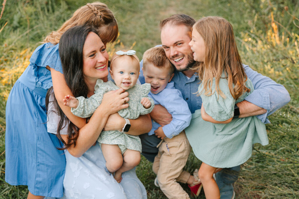 happy family during family photo session with four kids with fun family photographer Rachel Marie Photography in Hendersonville, NC