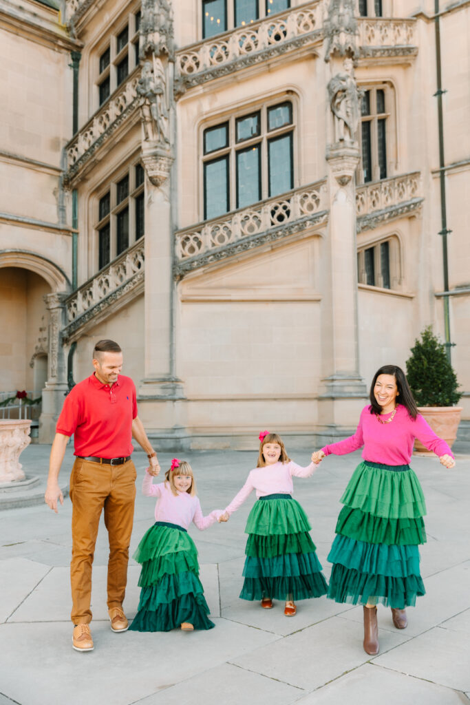 family runs around at the Biltmore Estate during Christmas photo session in Asheville, NC with family photographer Rachel Marie Photography