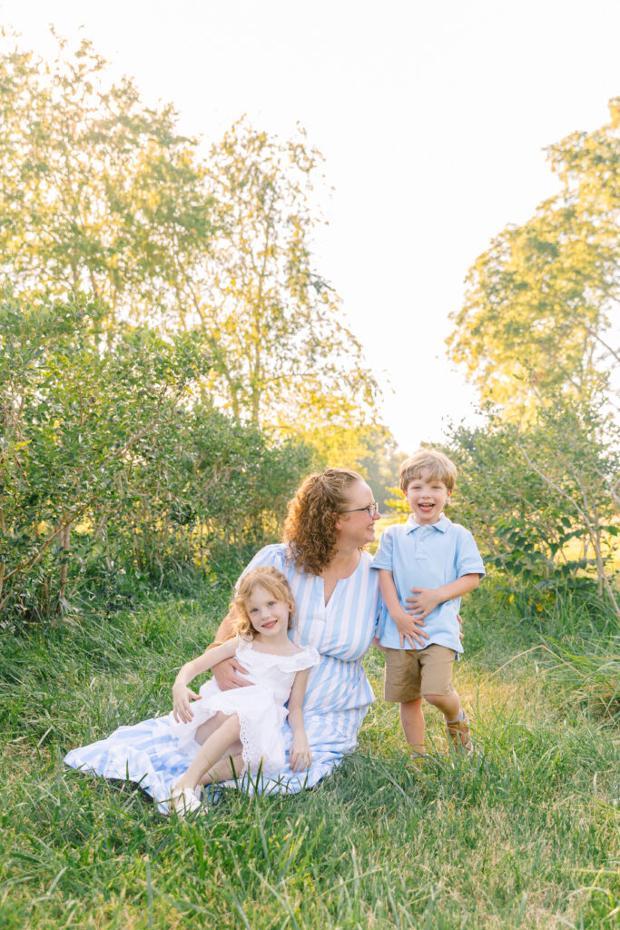 kids laughing and playing with mom during an outdoor family photo session in Asheville, NC with family and motherhood photographer Rachel Marie Photography