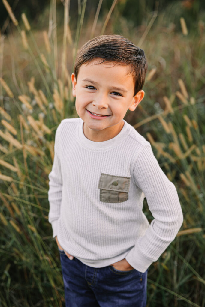 Boy poses for fall family photos with Asheville Family Photographer, Rachel Marie Photography