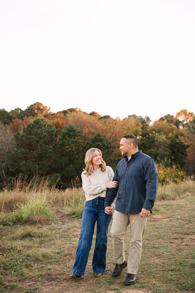 Husband and wife walking during fall family photo session with asheville family photographer