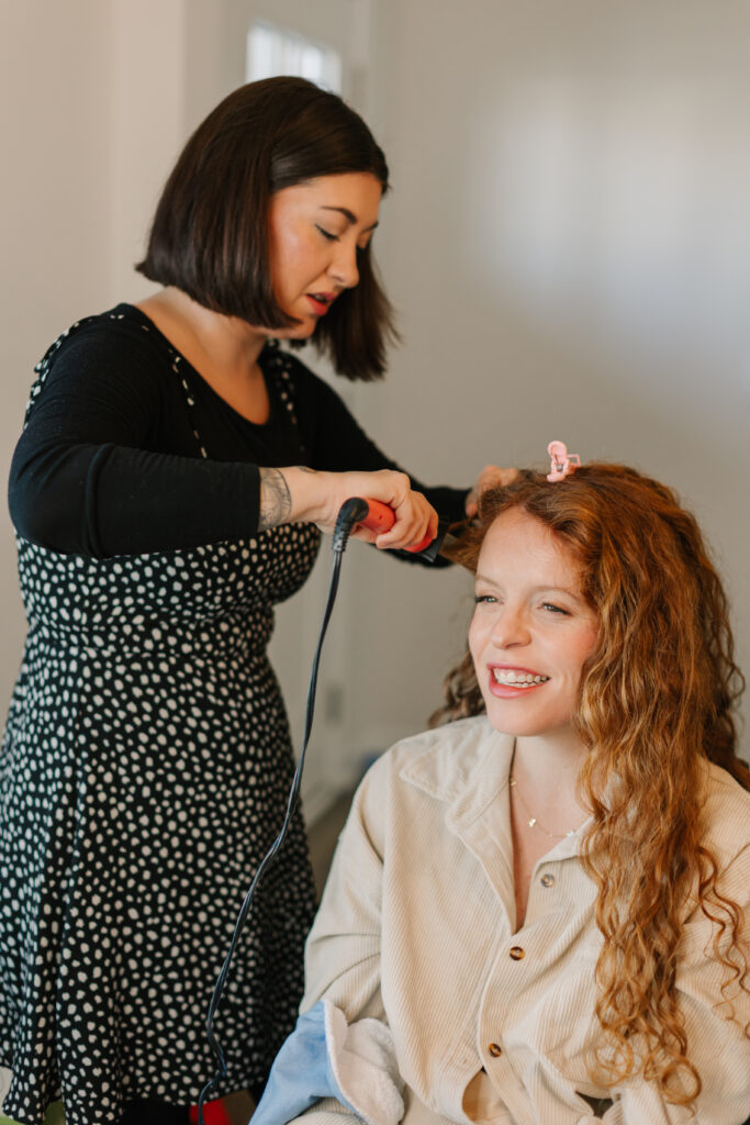 Mom pictured getting her hair and makeup done for newborn photoshoot. 