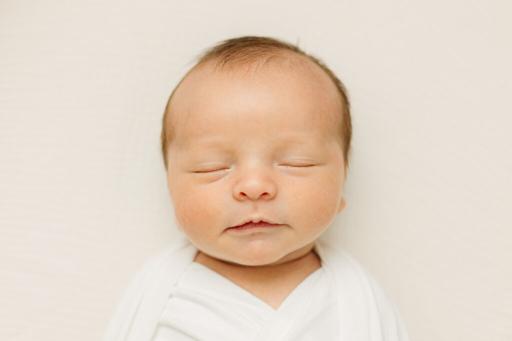 Newborn baby boy in swaddle during in-home newborn session with Rachel Marie Photography, a Newborn Photographer in the Asheville and Hendersonville area