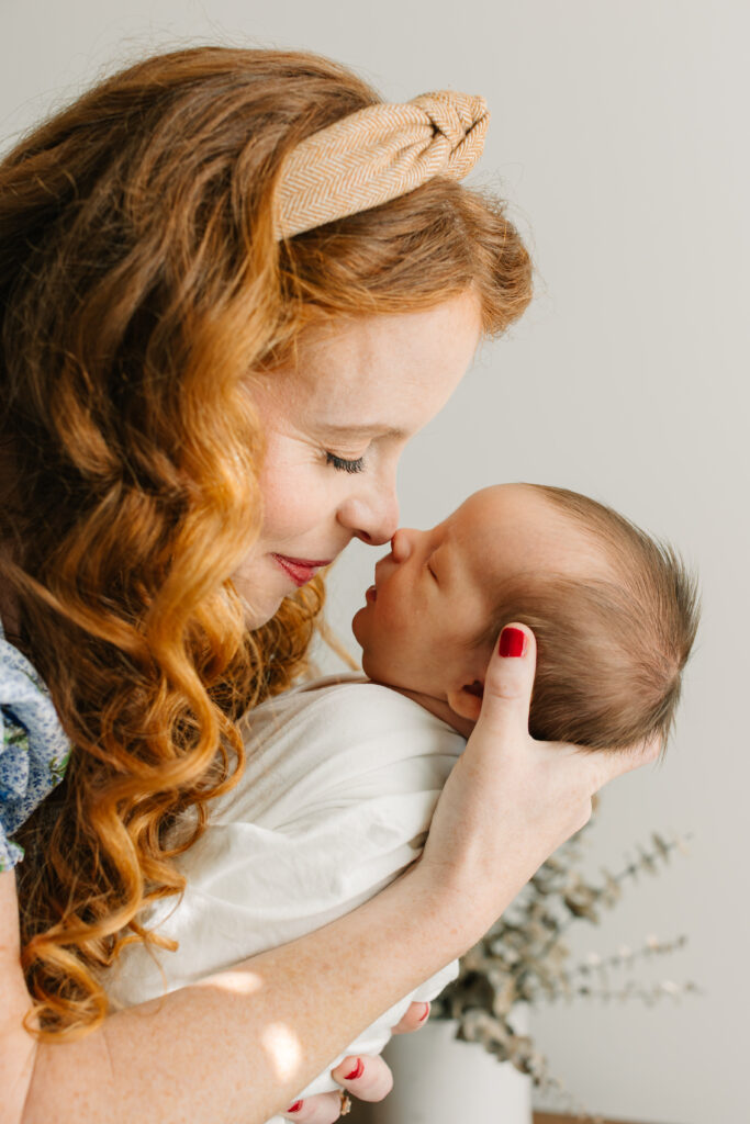 Mom pictured nose-to-nose during newborn photo session