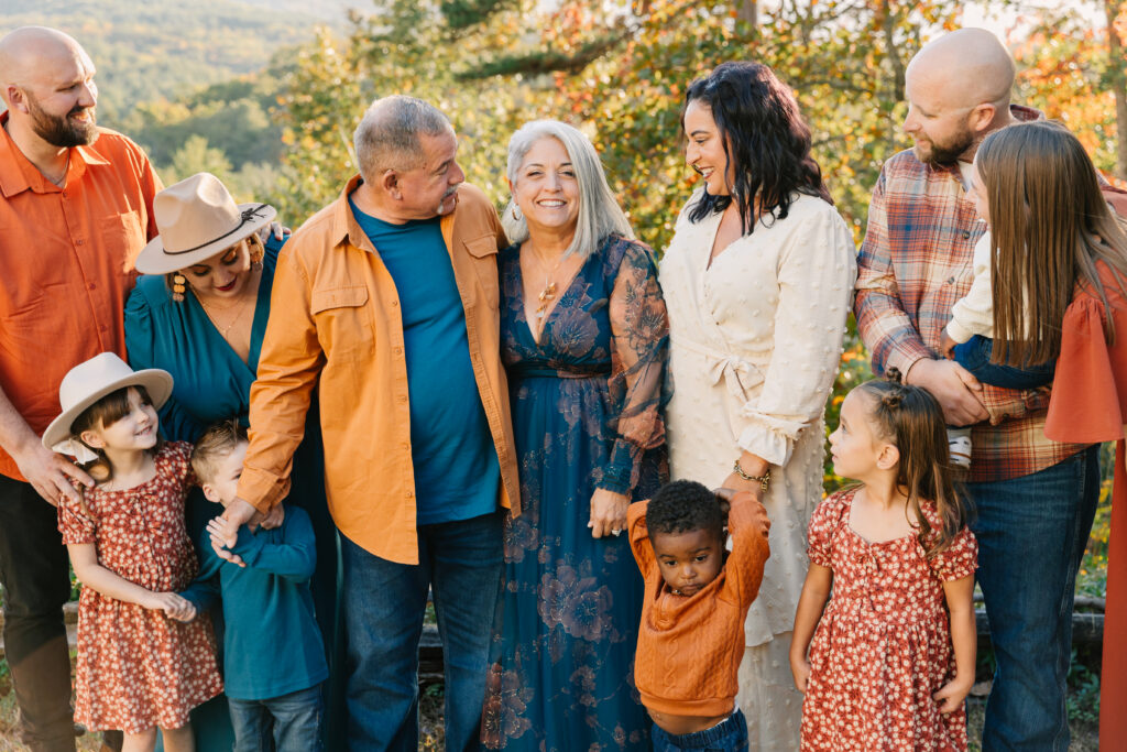 a multigenerational family smiles together in group photo during extended family photo session in Asheville, NC with family photographer Rachel Marie Photography