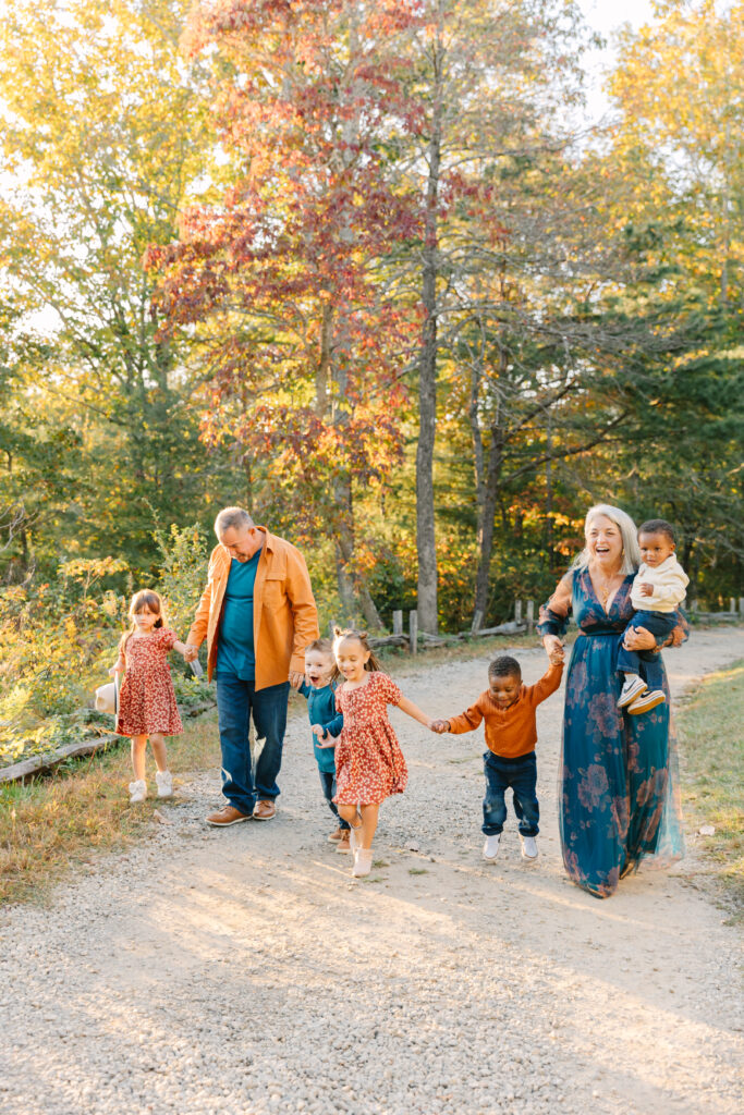 a multigenerational family smiles together in group photo during extended family photo session in Asheville, NC with family photographer Rachel Marie Photography