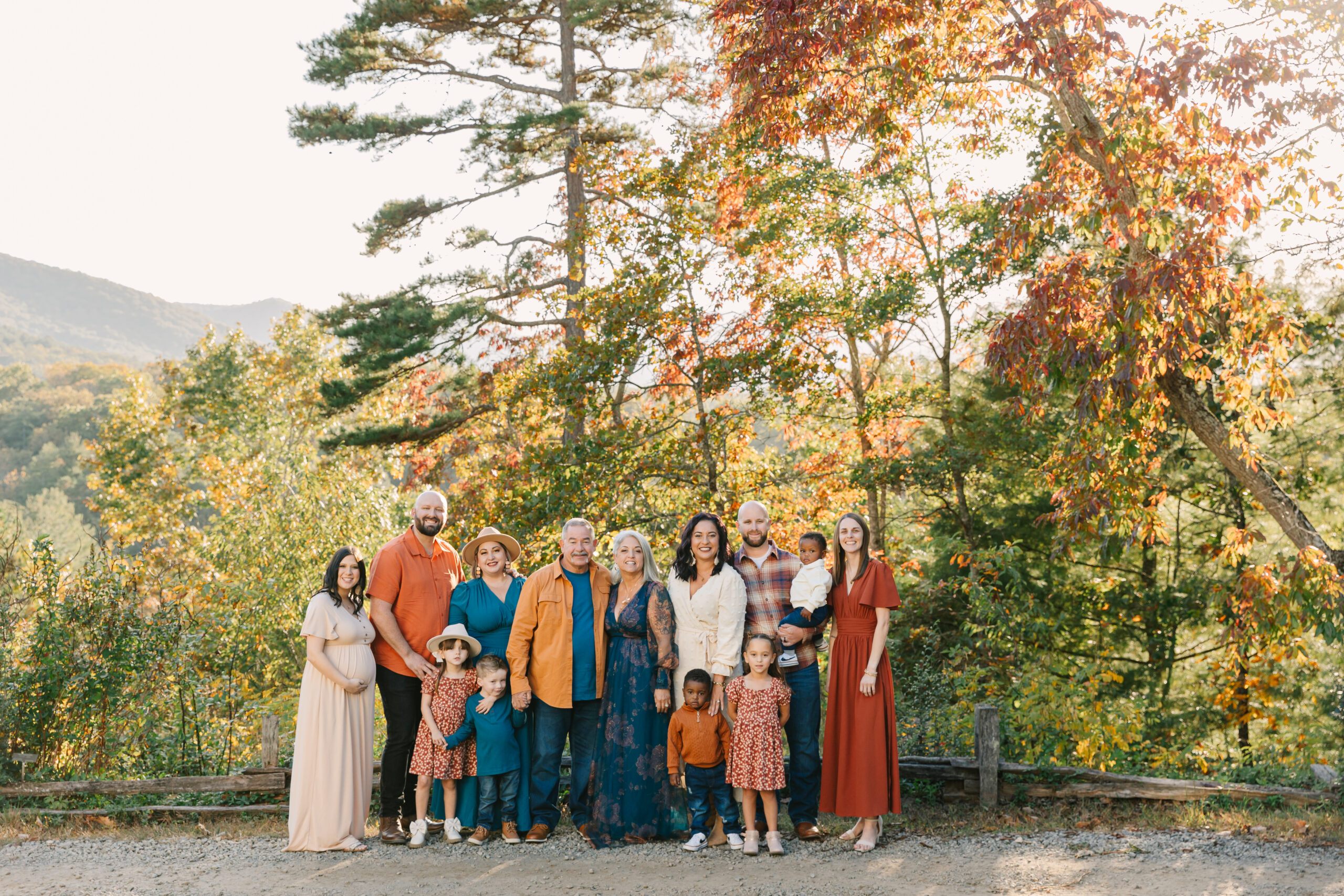 a multigenerational family smiles together in group photo during extended family photo session in Asheville, NC with family photographer Rachel Marie Photography