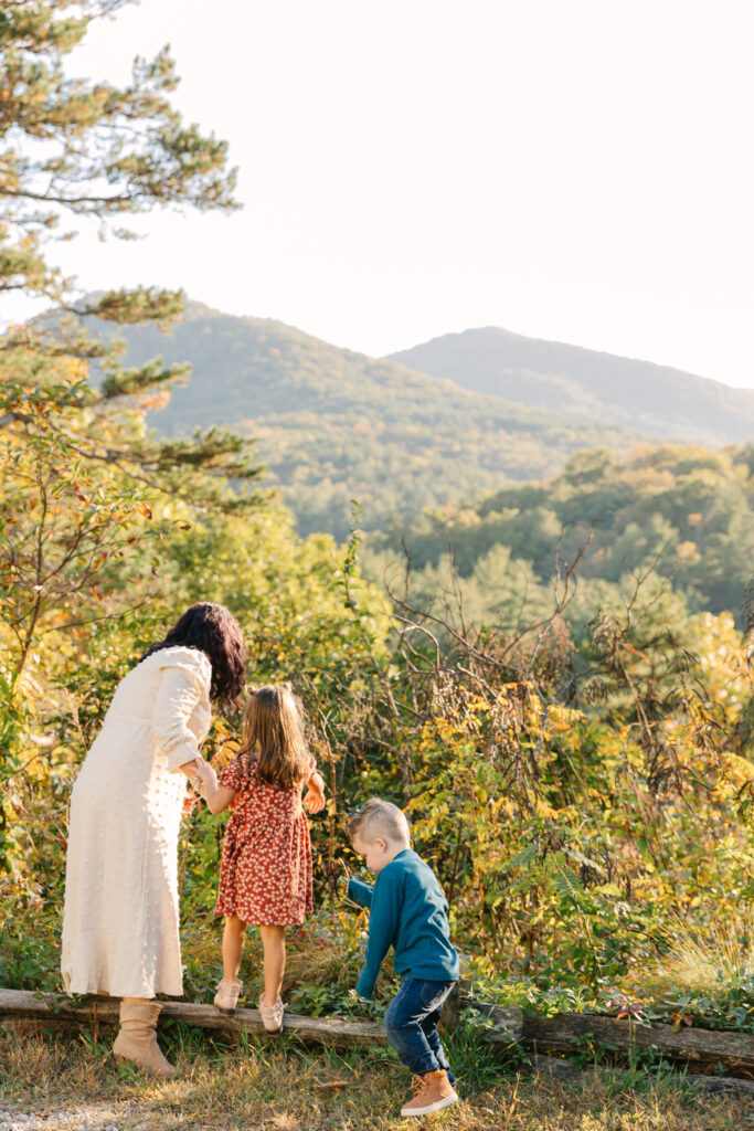 mom and kids play and explore together during extended family photo session in Asheville, NC with family photographer Rachel Marie Photography