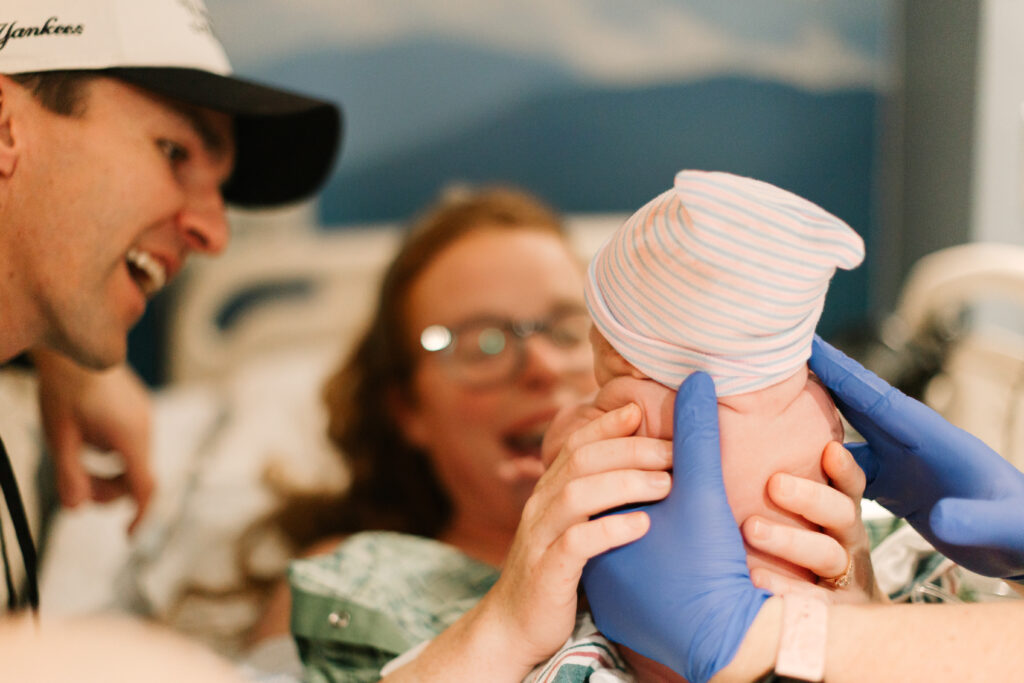 mother holds newborn baby boy she just delivered at mission hospital in Asheville, NC