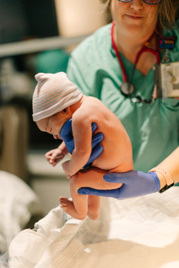 nurse holds newborn baby boy just after delivery at mission hospital in Asheville, NC