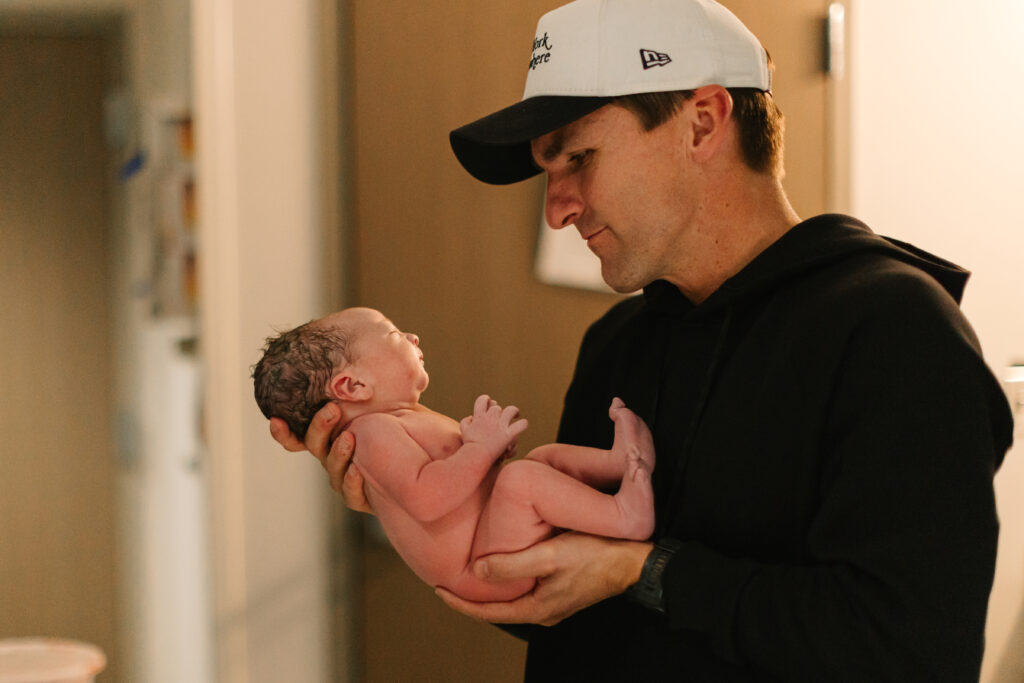 dad holds newborn baby boy just after delivery at mission hospital in Asheville, NC