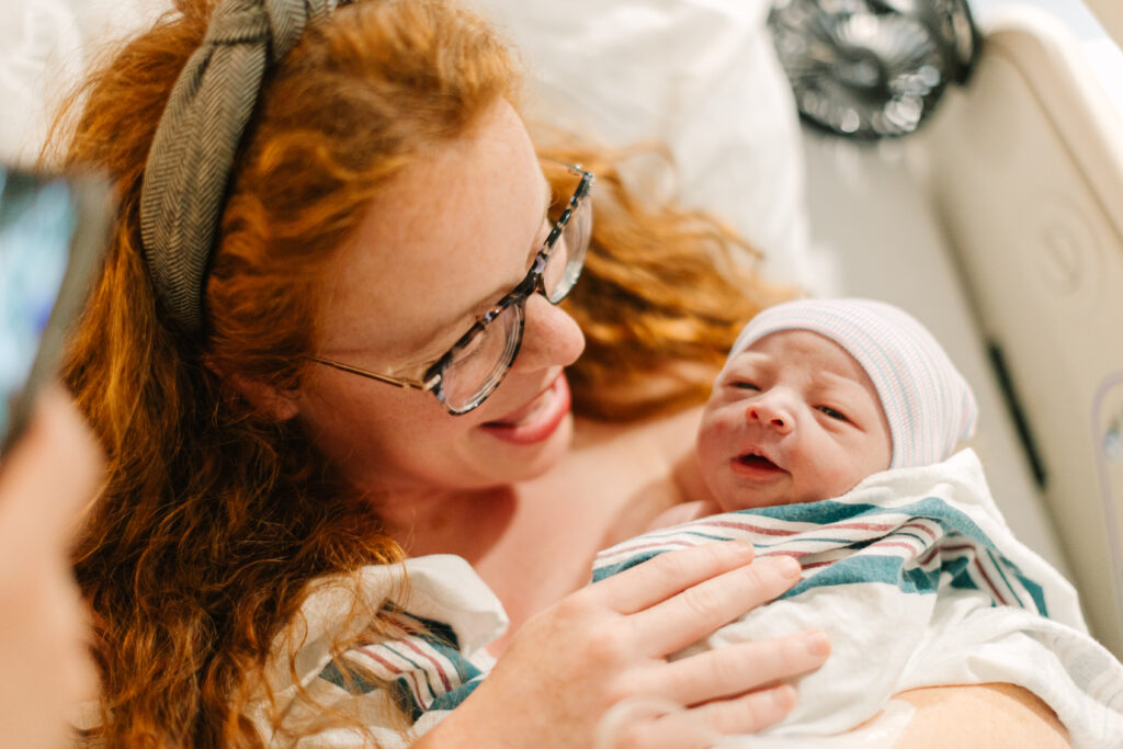 mother holds newborn baby boy just after delivery at mission hospital in Asheville, NC
