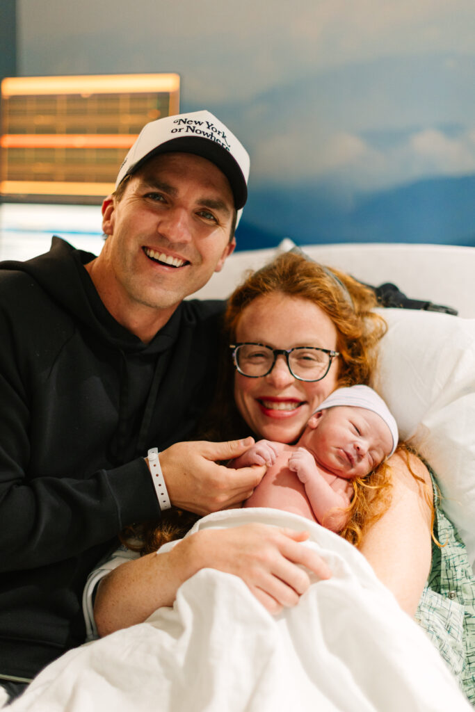 mom and dad hold newborn baby in hospital room just after delivery at mission hospital in Asheville, NC