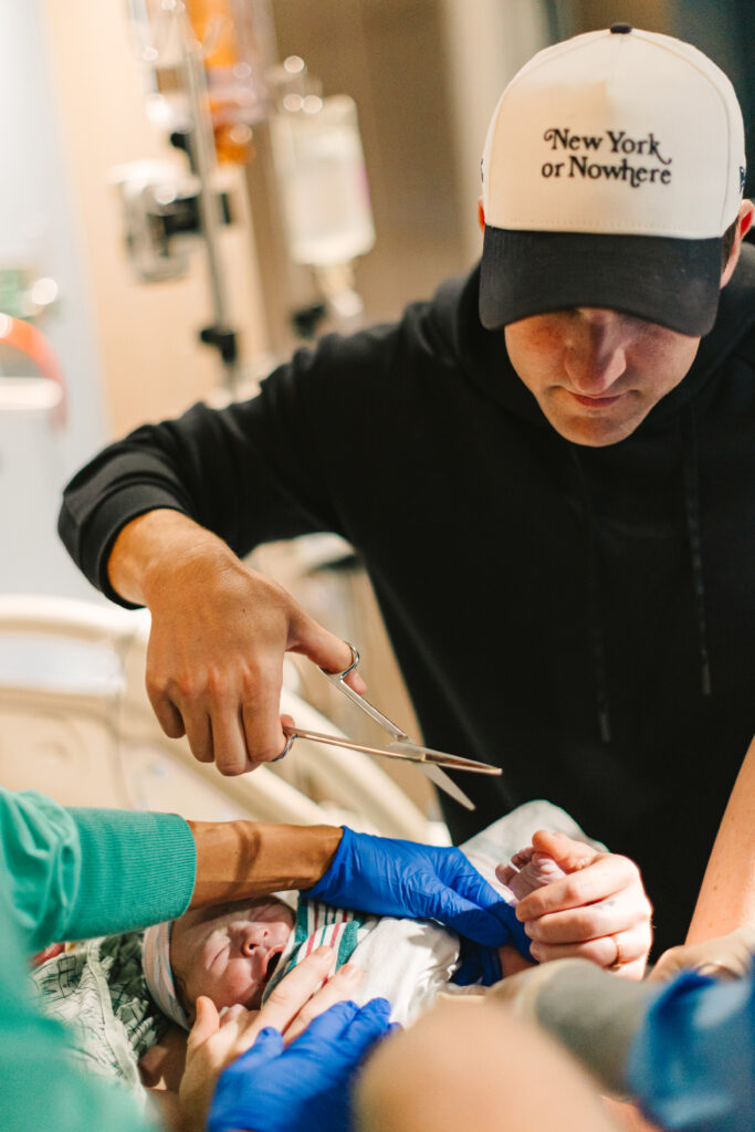 father prepares to cut his new son's umbilical cord after hospital birth at Mission Hospital in Asheville, NC