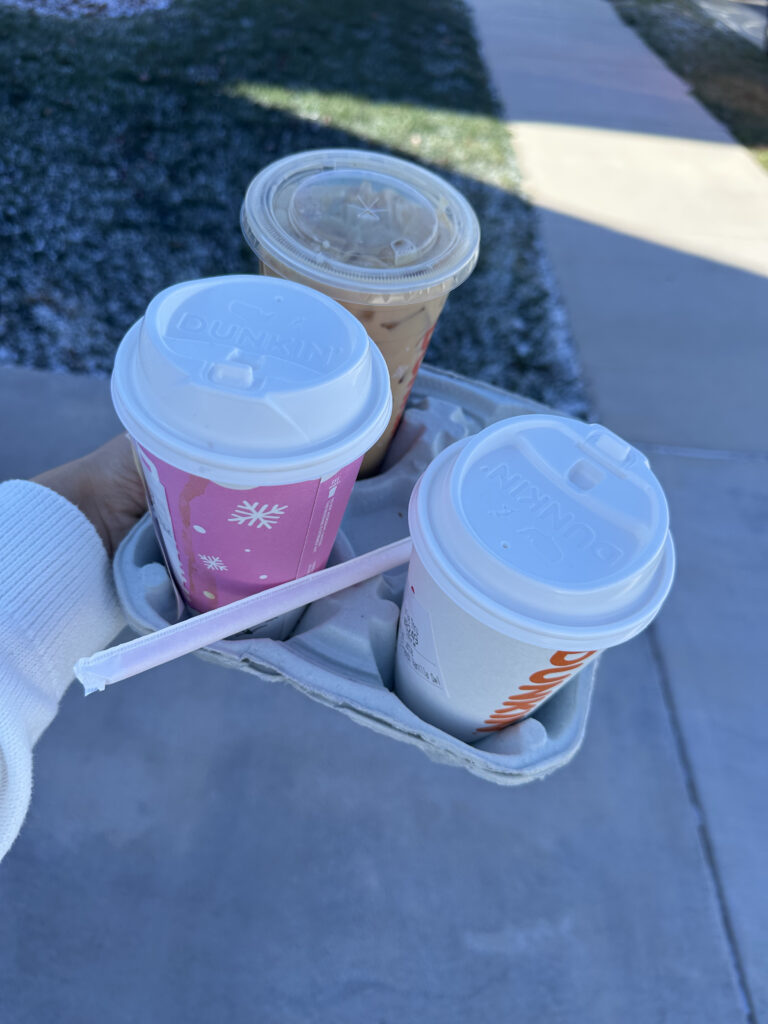 Asheville newborn family photographer holds dunkin donuts coffee drink for mama to sip on while getting her hair and make-up done for photos!